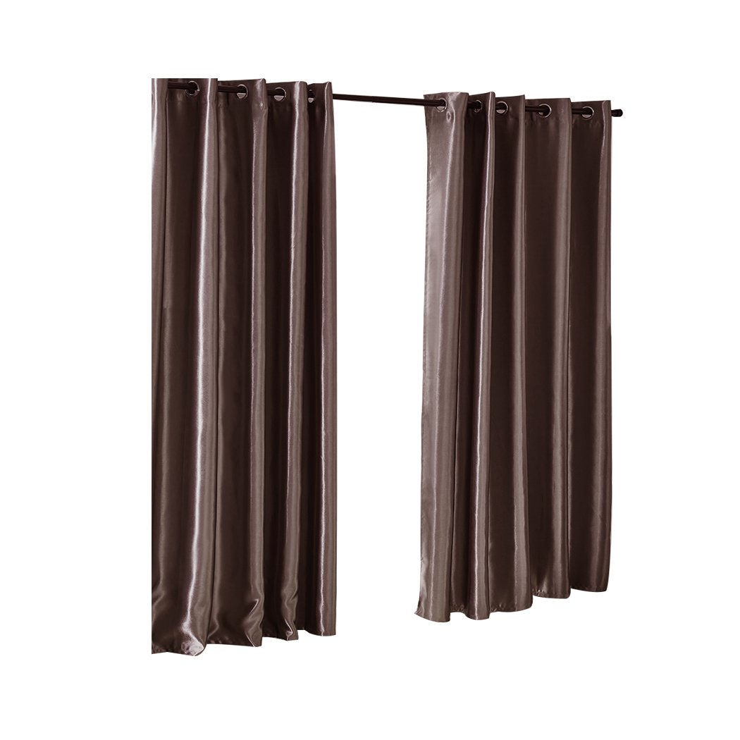 Elegant taupe 2X blockout curtains hanging in a bedroom, showcasing their luxurious texture and design.