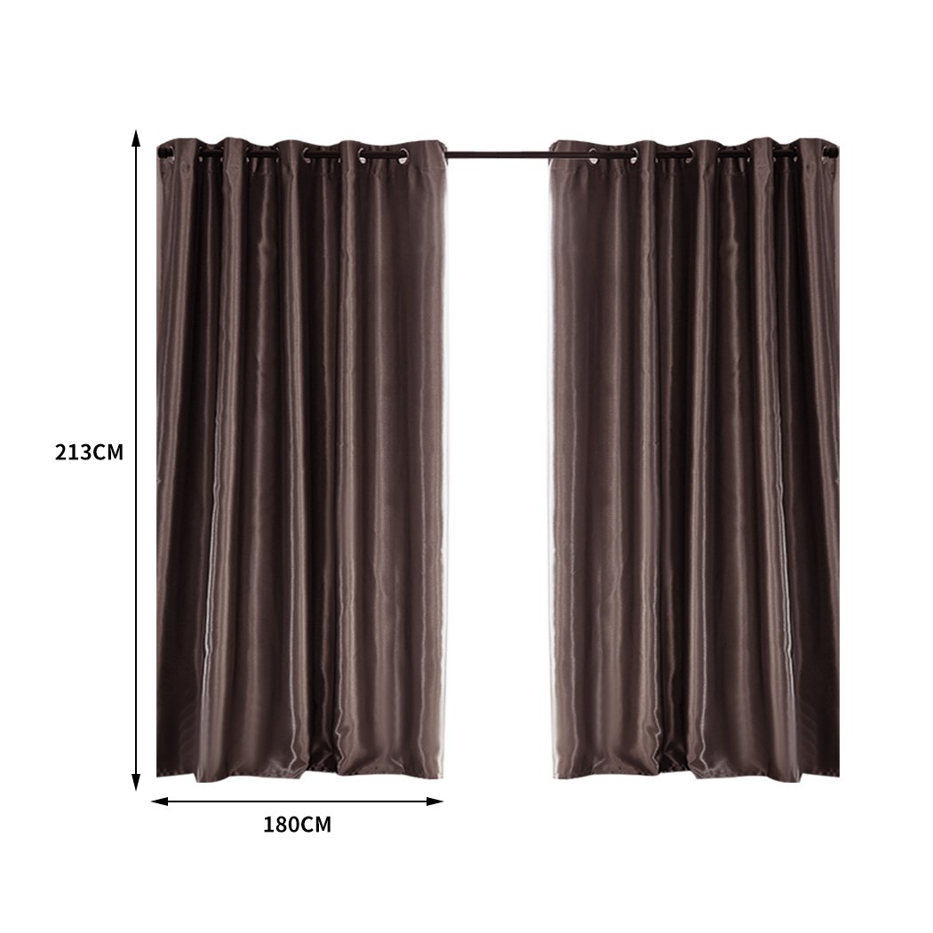 Elegant taupe 2X blockout curtains hanging in a bedroom, showcasing their luxurious texture and design.