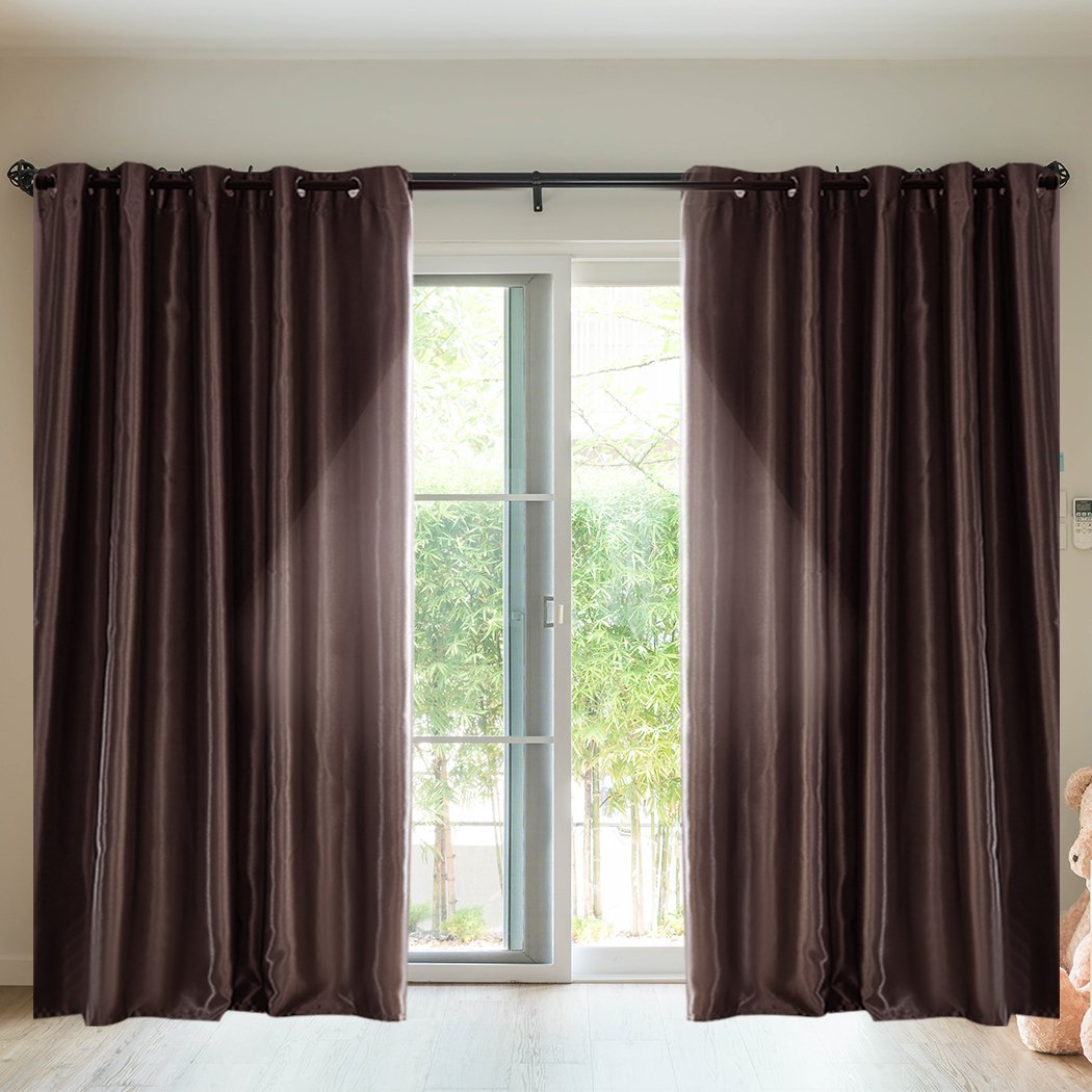 Elegant taupe 2X blockout curtains hanging in a bedroom, showcasing their luxurious texture and design.