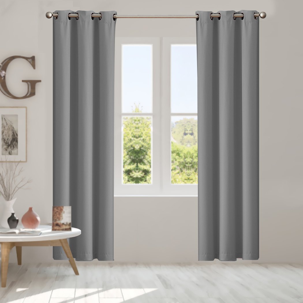 Two elegant blockout curtain panels in vibrant color, designed for room darkening and noise reduction, featuring eyelet design and triple weave fabric.