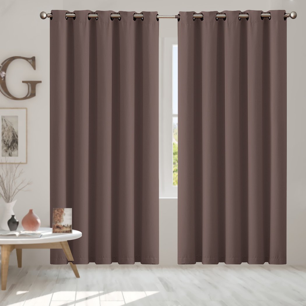 Two elegant blockout curtain panels in vibrant color, designed for room darkening and noise insulation, featuring eyelet design and triple weave fabric.