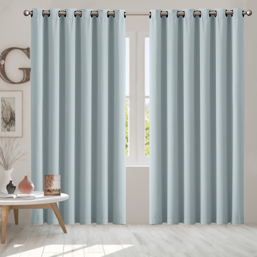 Two elegant blockout curtain panels in vibrant color, designed for room darkening and noise insulation, featuring eyelet design and triple weave fabric.