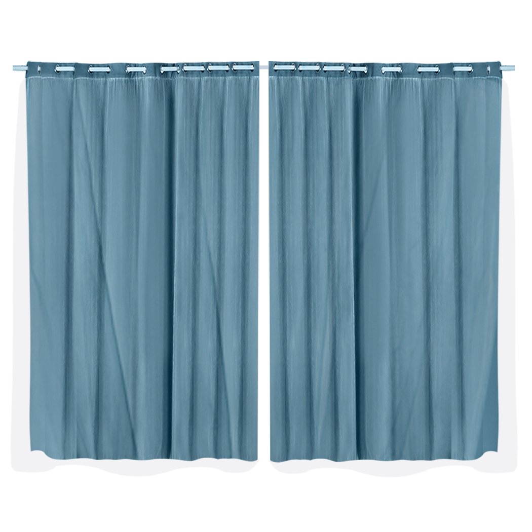 Two elegant blockout curtain panels in a modern living room setting, showcasing their 3-layer design and grommet top.