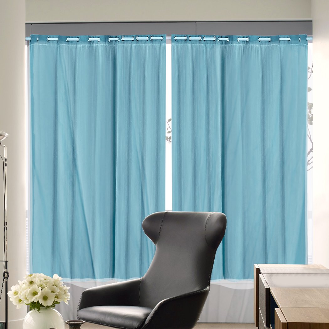 Two elegant blockout curtain panels in a modern living room setting, showcasing their 3-layer design and grommet top.