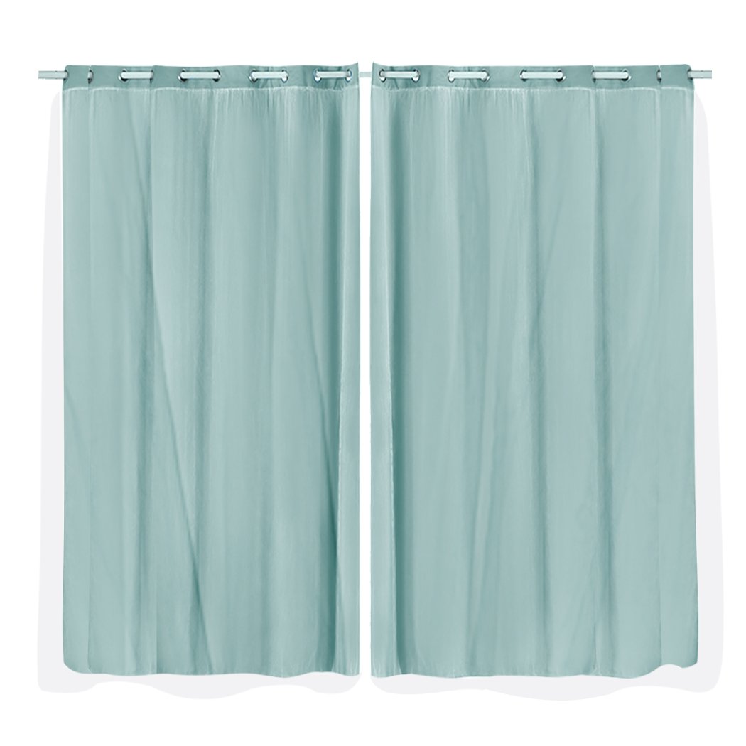 Two elegant blockout curtain panels with gauze, showcasing a 3-layer design for room darkening, hanging on a curtain rod.