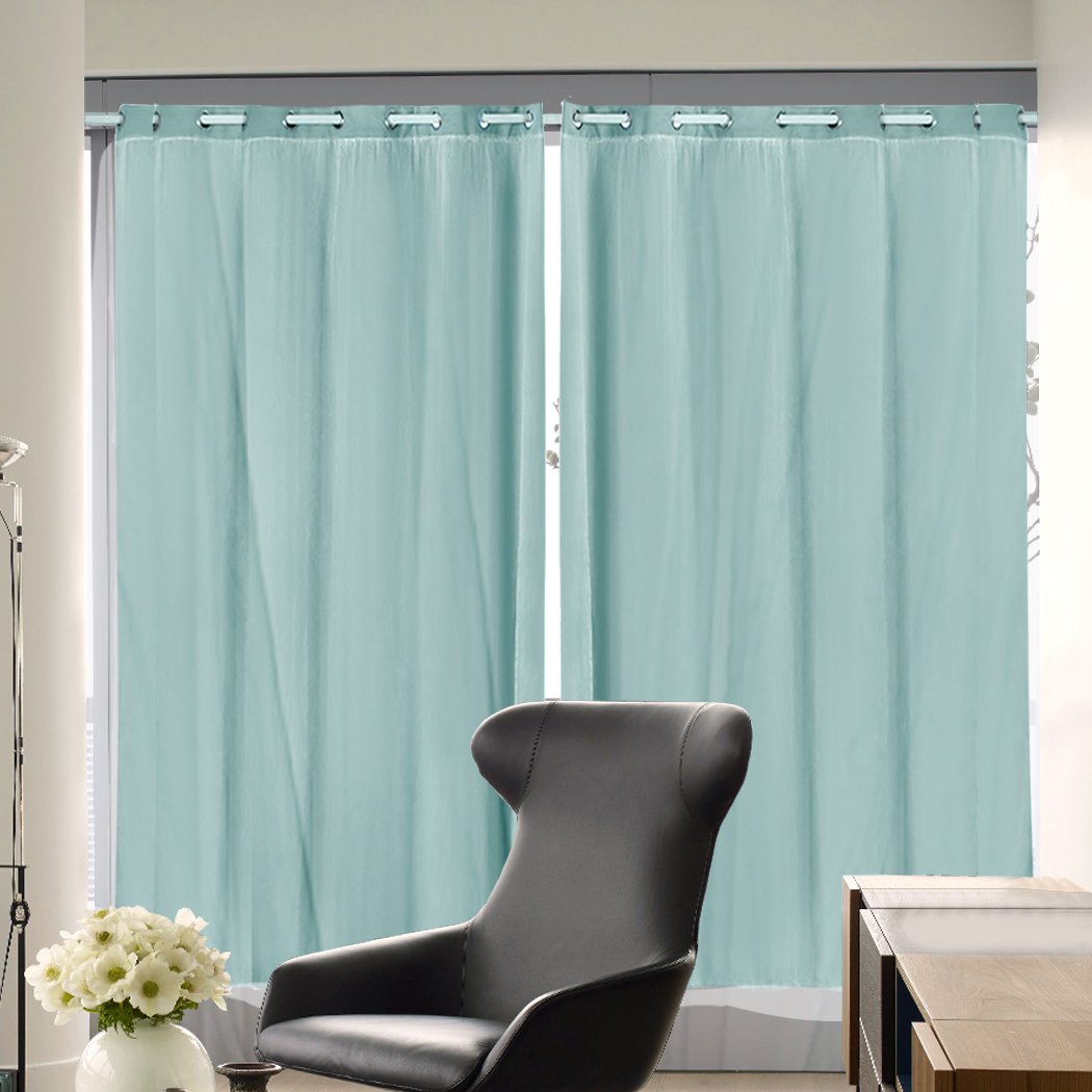 Two elegant blockout curtain panels with gauze, showcasing a 3-layer design for room darkening, hanging on a curtain rod.