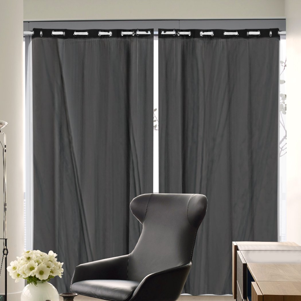 Two elegant blockout curtain panels with gauze, showcasing a rich texture and grommet top design, perfect for room darkening.