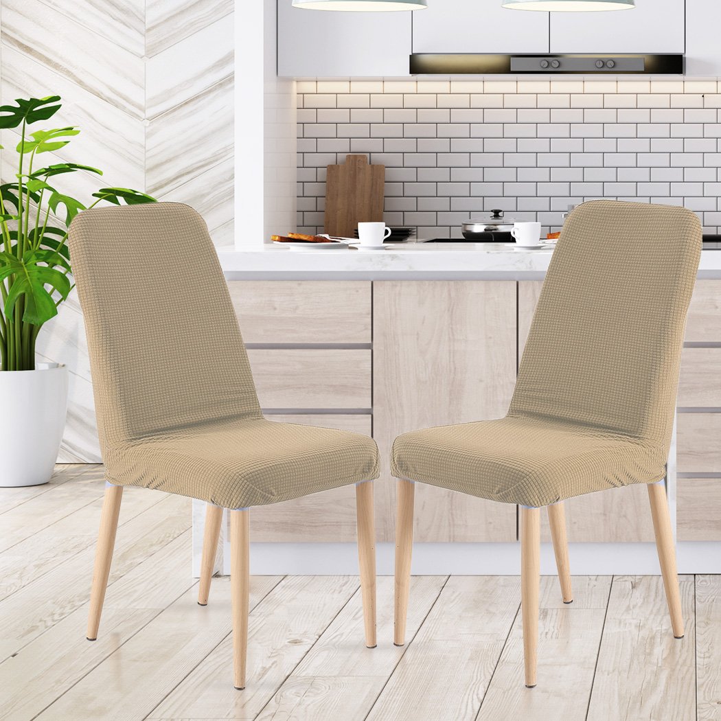 Two khaki spandex dining chair covers designed for protection and style, showcasing their stretchable and machine washable fabric.