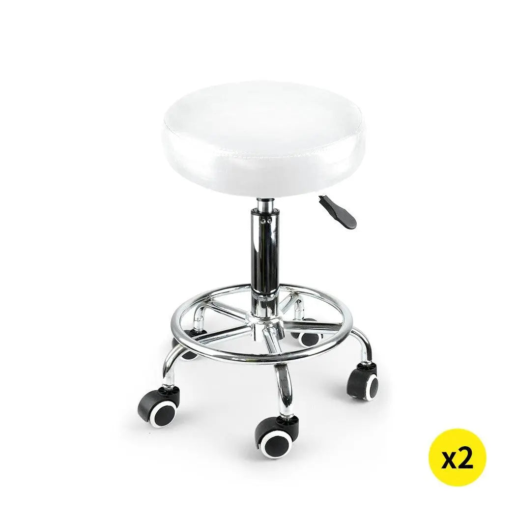 Two Levede swivel salon barstools with white PU leather cushions and silver chromed iron bases, showcasing their elegant design and functionality.