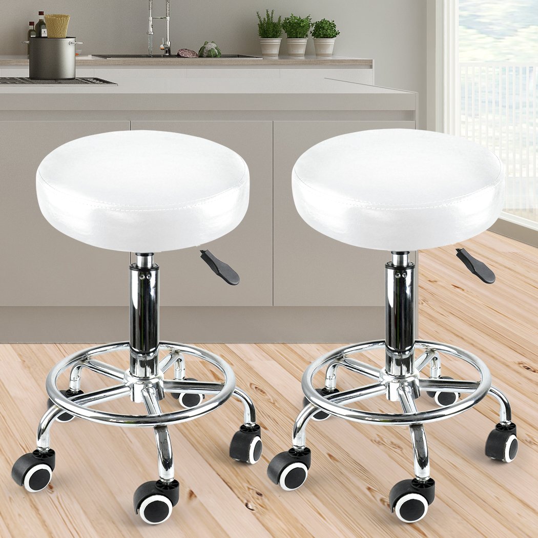 Two Levede swivel salon barstools with white PU leather cushions and silver chromed iron bases, showcasing their elegant design and functionality.