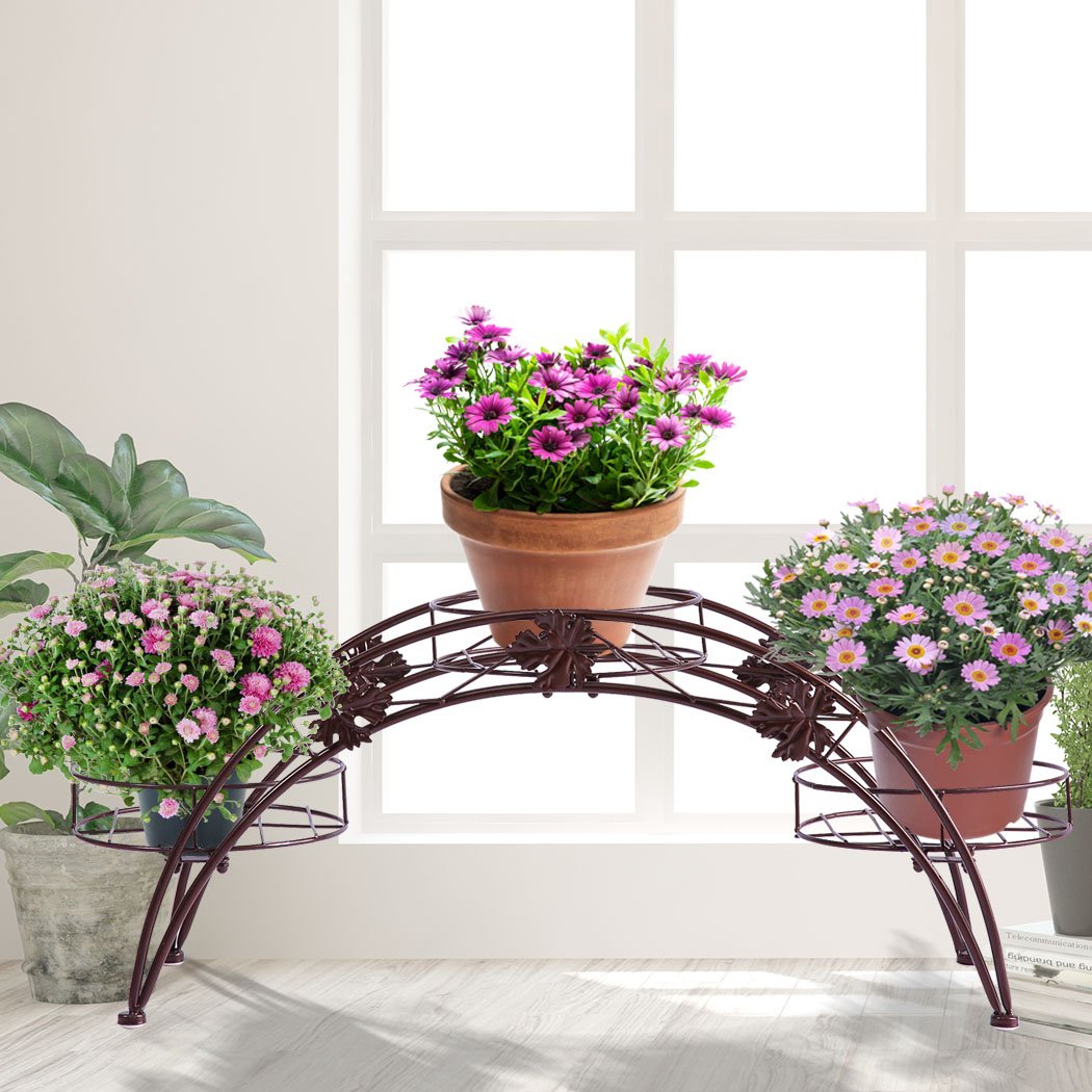 Two elegant bronze metal plant stands designed for indoor and outdoor use, showcasing a delicate imitation rattan design.