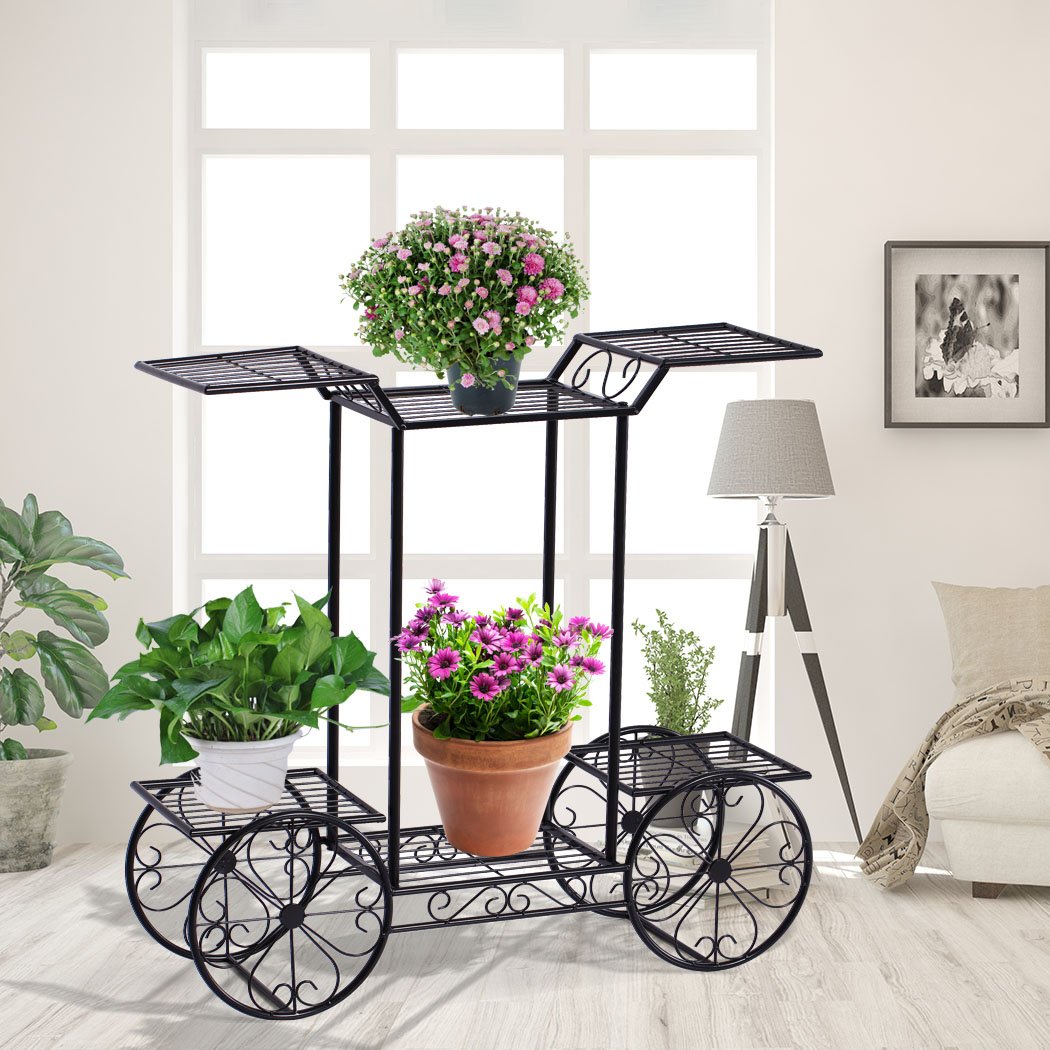 Two elegant wrought iron plant stands showcasing vibrant green plants, suitable for indoor and outdoor use.