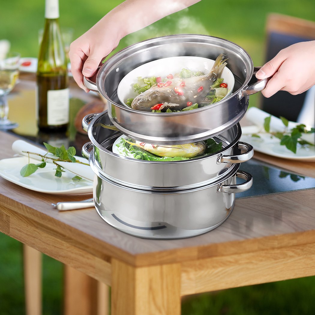 4 Tier Stainless Steel Steamer with glass lid, showcasing its multiple layers and sleek design, ideal for cooking meat and vegetables.