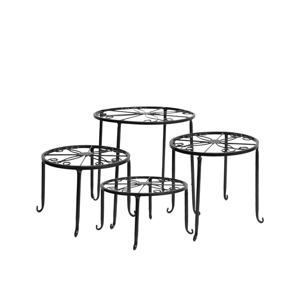 Four black metal plant stands arranged with various flower pots, showcasing an elegant outdoor and indoor decor.