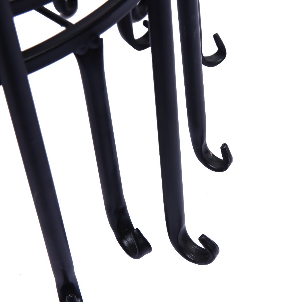 Four black metal plant stands arranged with various flower pots, showcasing an elegant outdoor and indoor decor.