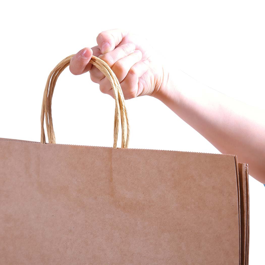 A stack of 50 eco-friendly brown paper bags with twisted hemp cord handles, showcasing their sturdy design and recyclable material.