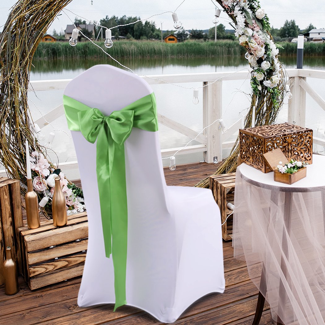 50 satin chair sashes in various colors elegantly draped over chairs for event decoration.