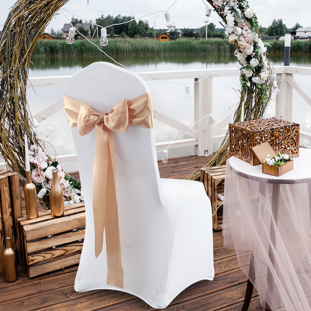 50 satin chair sashes in various colors elegantly draped over chairs for event decoration.