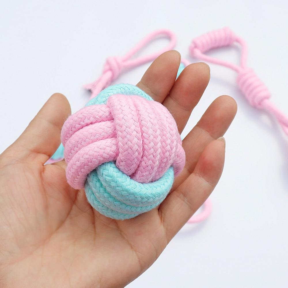 Five colorful cotton rope toys for dogs, designed for chewing and dental cleaning, featuring knots and a vibrant pink color.