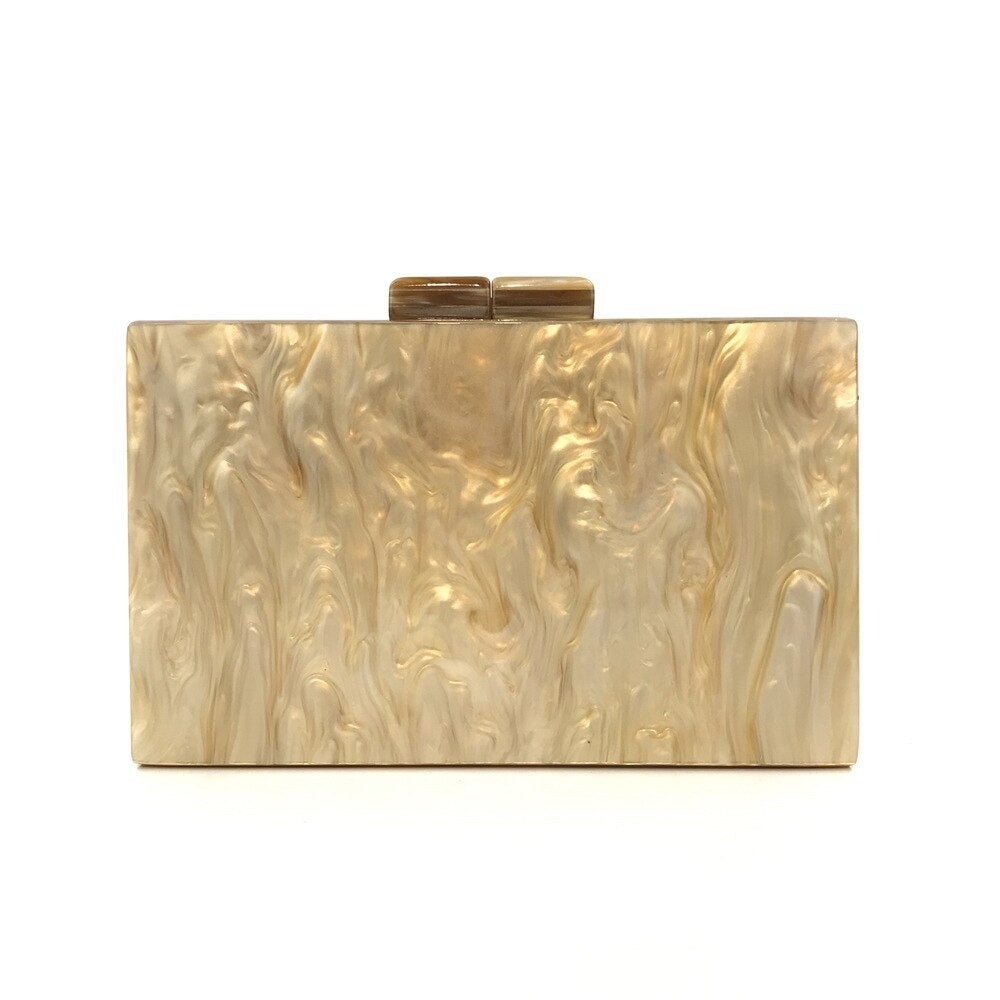 Acrylic luxury evening bag with a golden metal chain shoulder strap, featuring a stylish striped pattern and flap design.