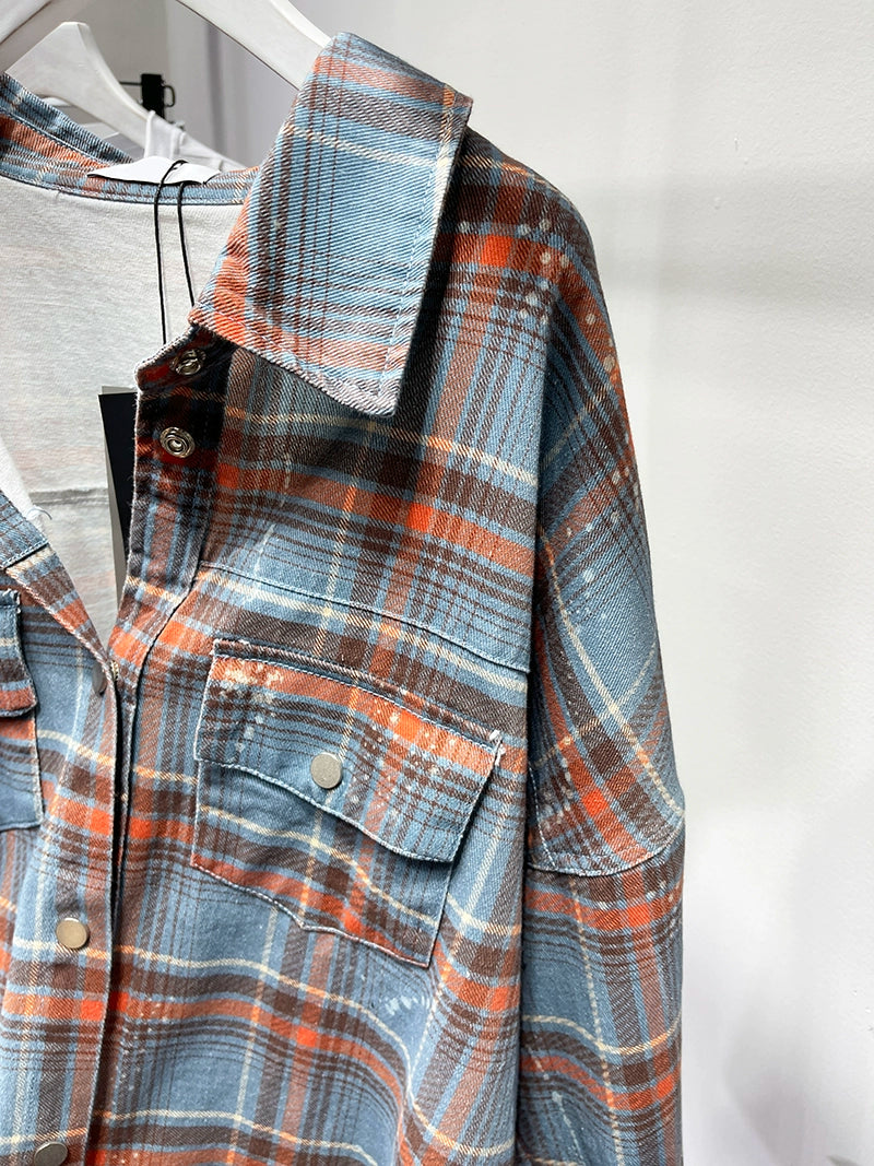 A stylish plaid shirt featuring a loose fit, designed for comfort and a youthful appearance, available in various colors.