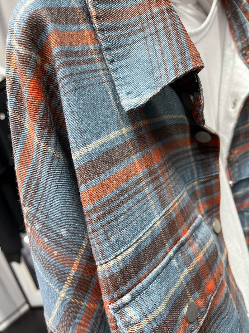 A stylish plaid shirt featuring a loose fit, designed for comfort and a youthful appearance, available in various colors.