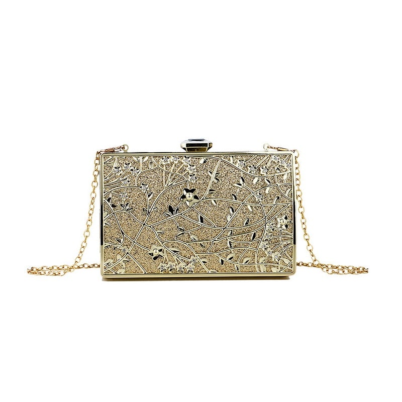 Luxurious golden evening bag with hollow out design, adorned with diamonds and a chain shoulder strap, perfect for formal occasions.