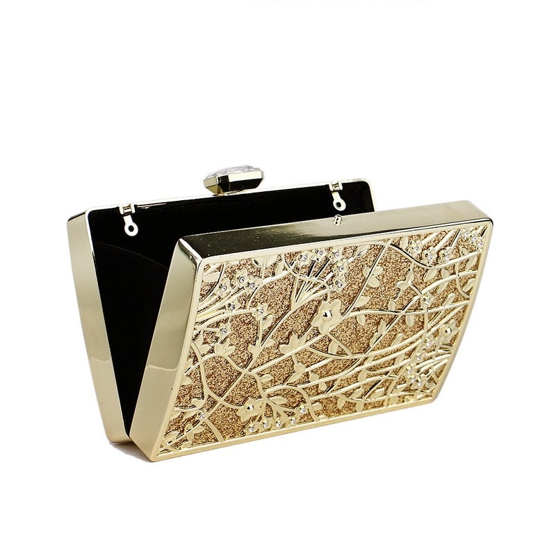 Luxurious golden evening bag with hollow out design, adorned with diamonds and a chain shoulder strap, perfect for formal occasions.