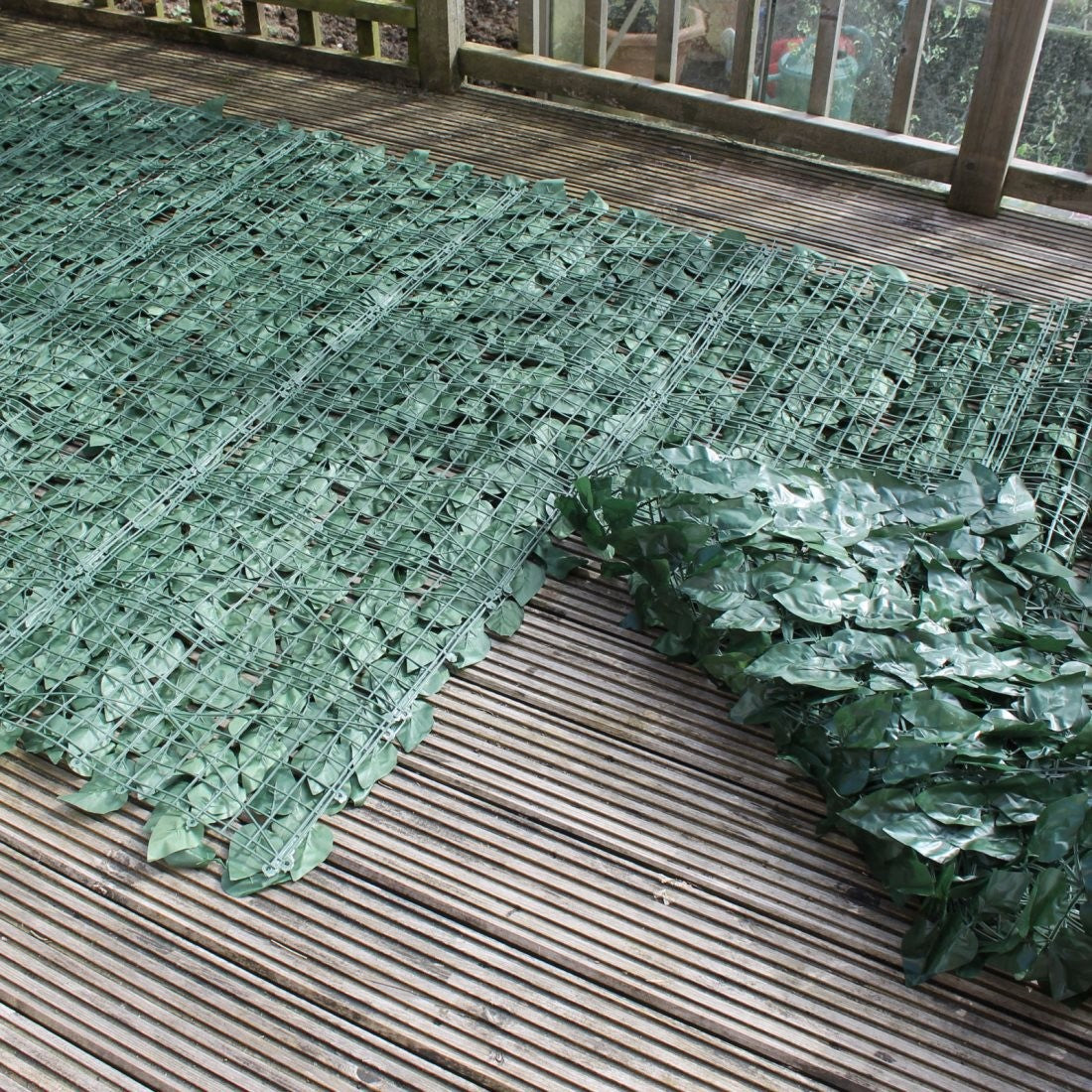 A roll of Artificial Ivy Leaf Hedging measuring 3m x 1m, showcasing lush green leaves ideal for privacy and decoration.