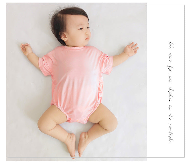 Baby unisex solid color rompers in various colors including pink, blue, green, and yellow, made from soft cotton blend fabric.