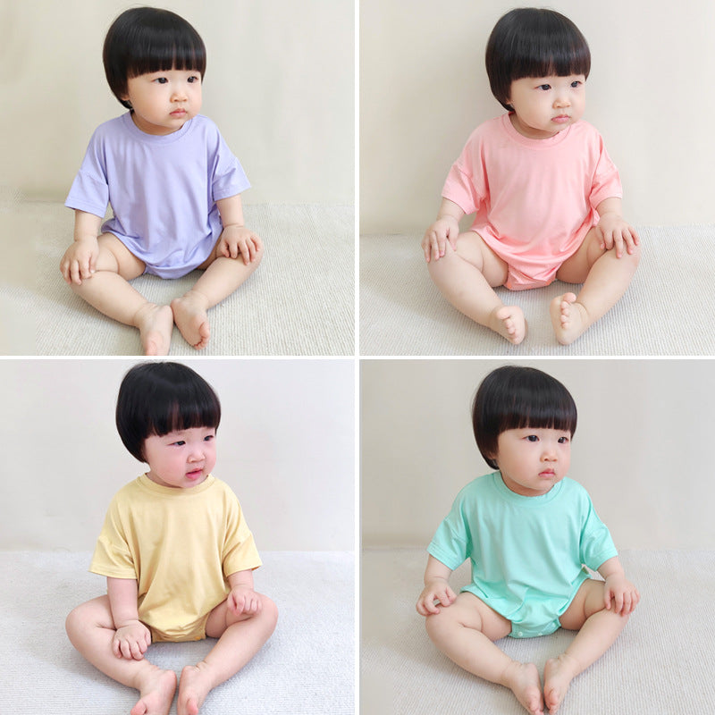 Baby unisex solid color rompers in various colors including pink, blue, green, and yellow, made from soft cotton blend fabric.