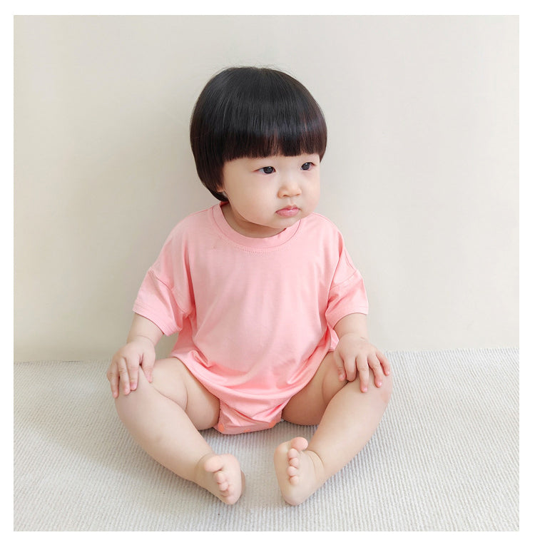 Baby unisex solid color rompers in various colors including pink, blue, green, and yellow, made from soft cotton blend fabric.