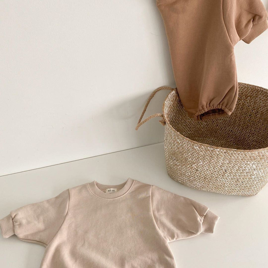 Baby unisex solid color rompers in beige and coffee, made from a soft cotton blend, suitable for boys and girls aged 3-18 months.