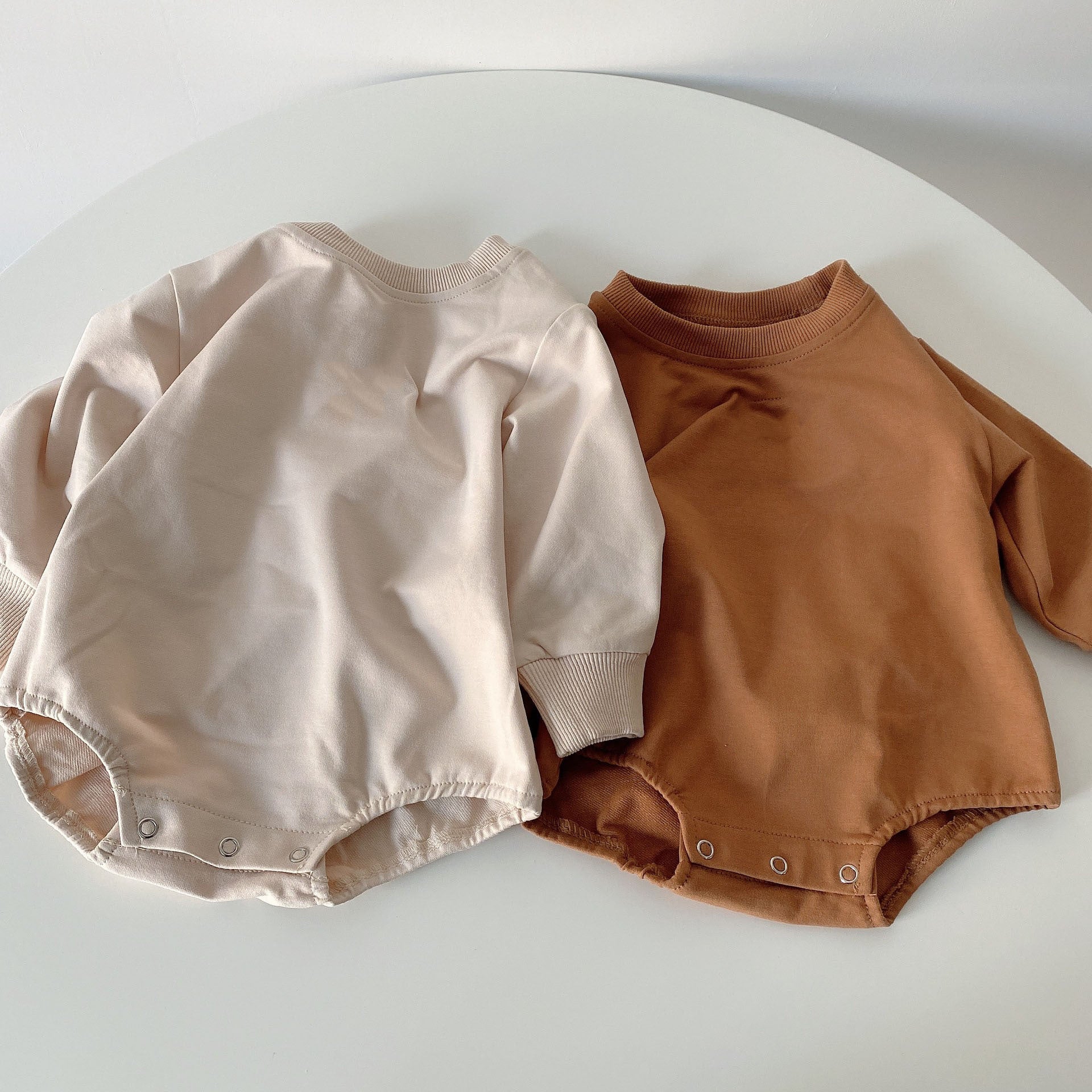 Baby unisex solid color rompers in beige and coffee, made from a soft cotton blend, suitable for boys and girls aged 3-18 months.