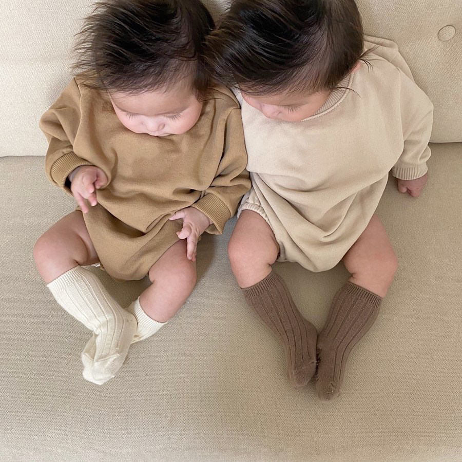 Baby unisex solid color rompers in beige and coffee, made from a soft cotton blend, suitable for boys and girls aged 3-18 months.