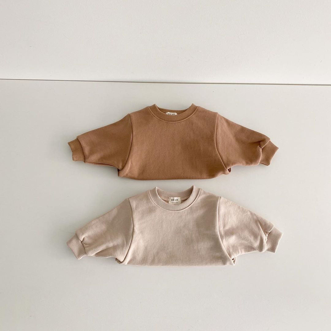 Baby unisex solid color rompers in beige and coffee, made from a soft cotton blend, suitable for boys and girls aged 3-18 months.