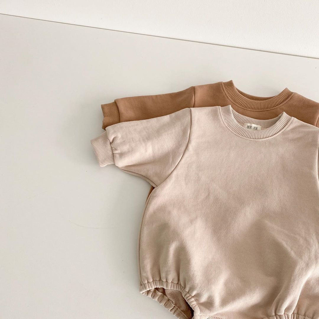 Baby unisex solid color rompers in beige and coffee, made from a soft cotton blend, suitable for boys and girls aged 3-18 months.