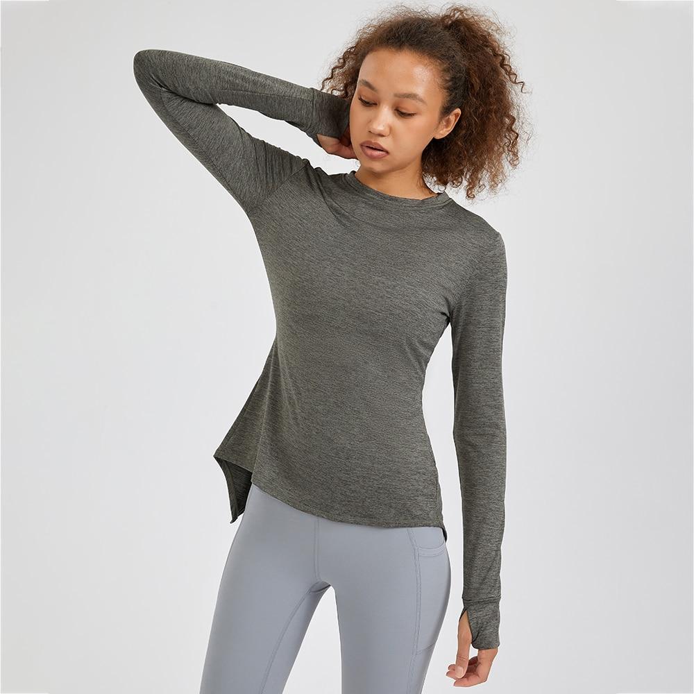 A stylish back open long sleeve training fitness yoga shirt for women, featuring a crew neck and thumb holes, perfect for workouts.