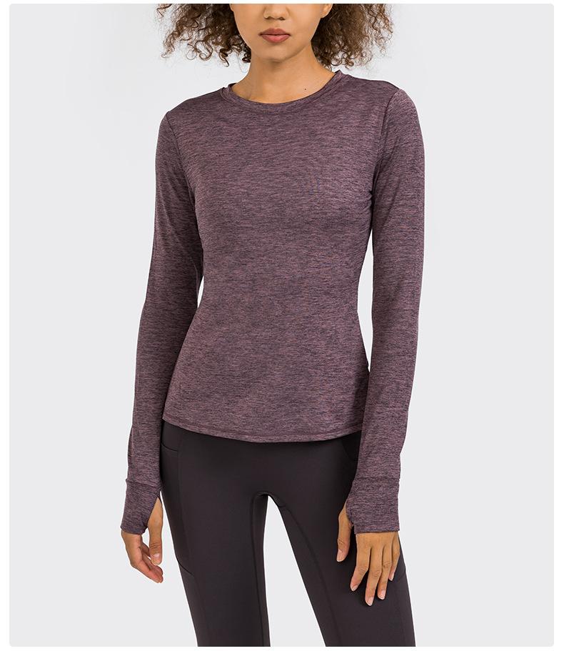 A stylish back open long sleeve training fitness yoga shirt for women, featuring a crew neck and thumb holes, perfect for workouts.