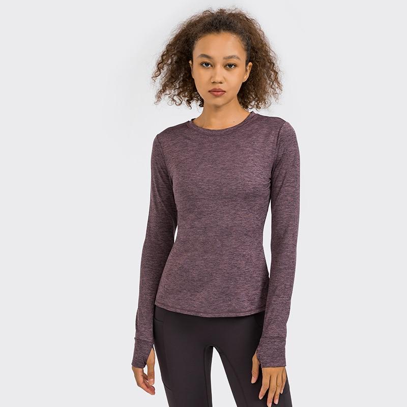 A stylish back open long sleeve training fitness yoga shirt for women, featuring a crew neck and thumb holes, perfect for workouts.