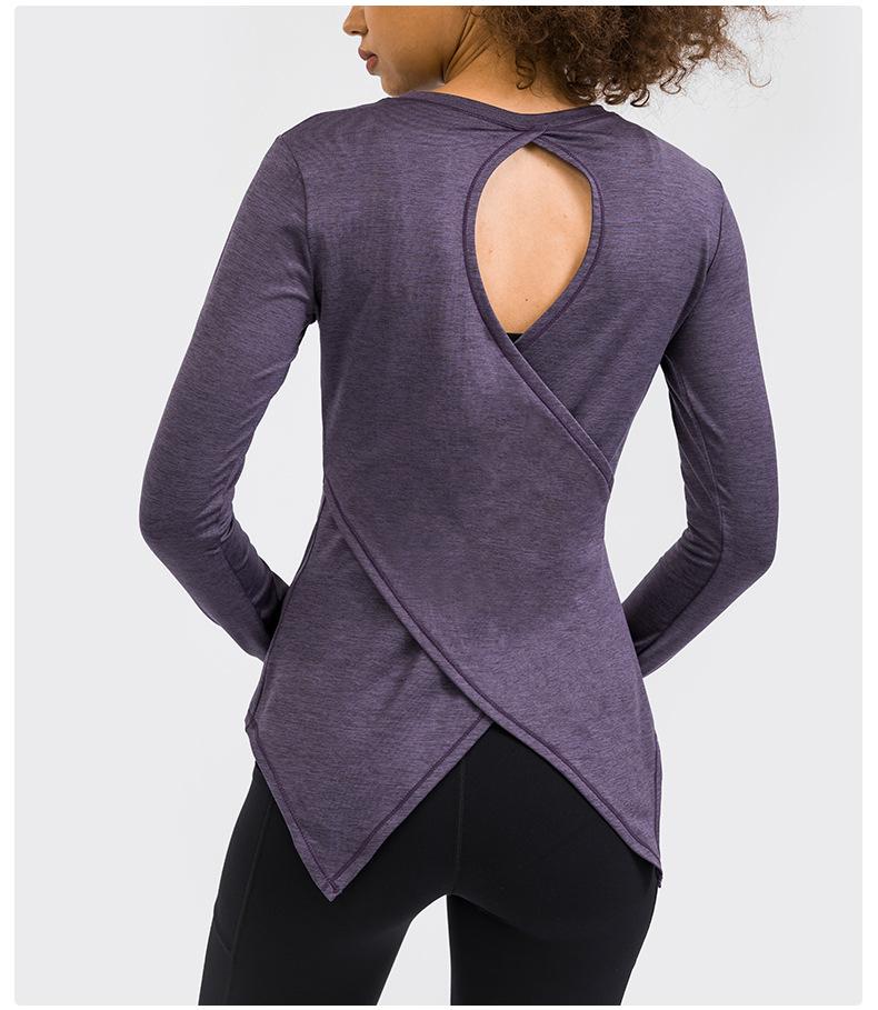 A stylish back open long sleeve training fitness yoga shirt for women, featuring a crew neck and thumb holes, perfect for workouts.