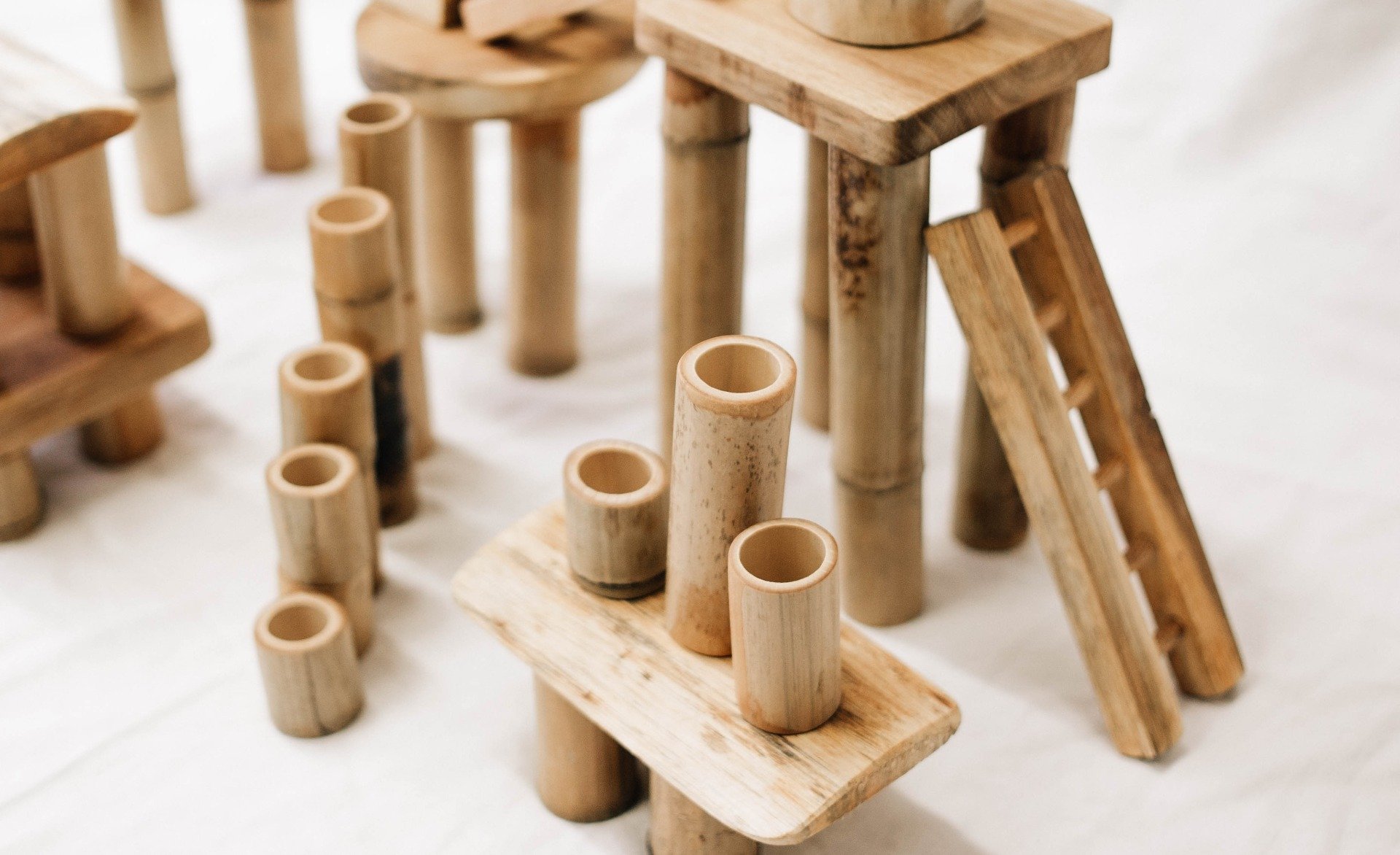 A colorful assortment of 50 bamboo building blocks arranged creatively, showcasing their natural texture and unique colors.