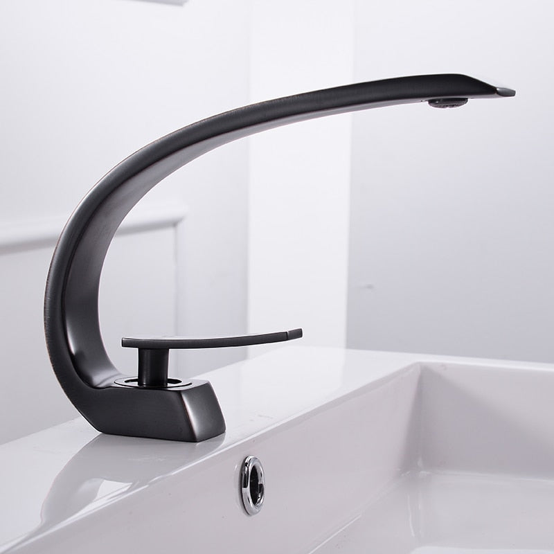 Modern brass basin faucet with single handle and sleek design, available in chrome, brushed nickel, and black finishes.