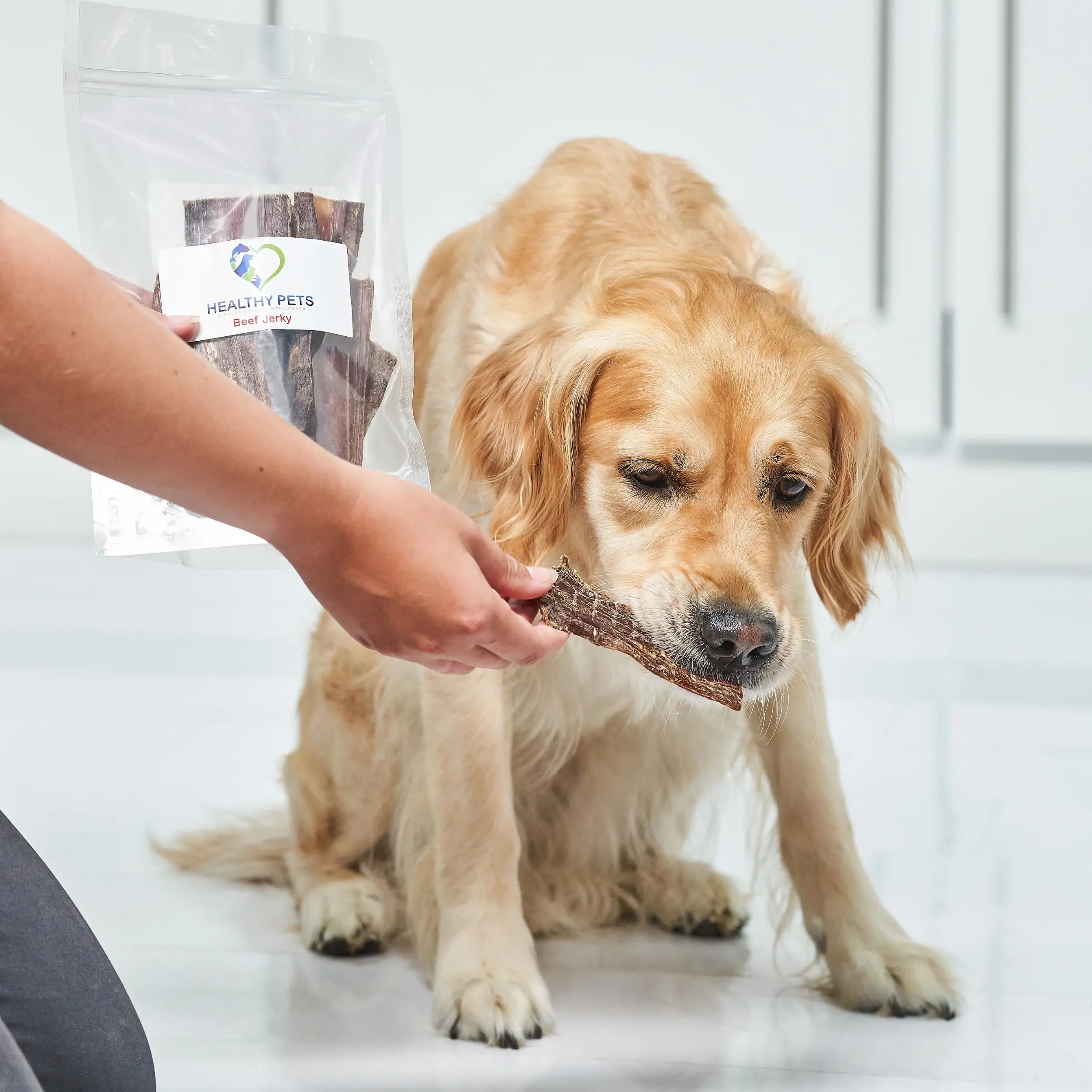 A pack of organic natural beef jerky dog treats, showcasing the chewy texture and rich color of the beef.