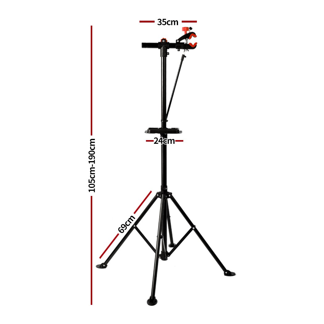 Ergonomic bike repair stand with tool tray, featuring a 360° swivel clamp and a sturdy four-legged base, ideal for home mechanics.