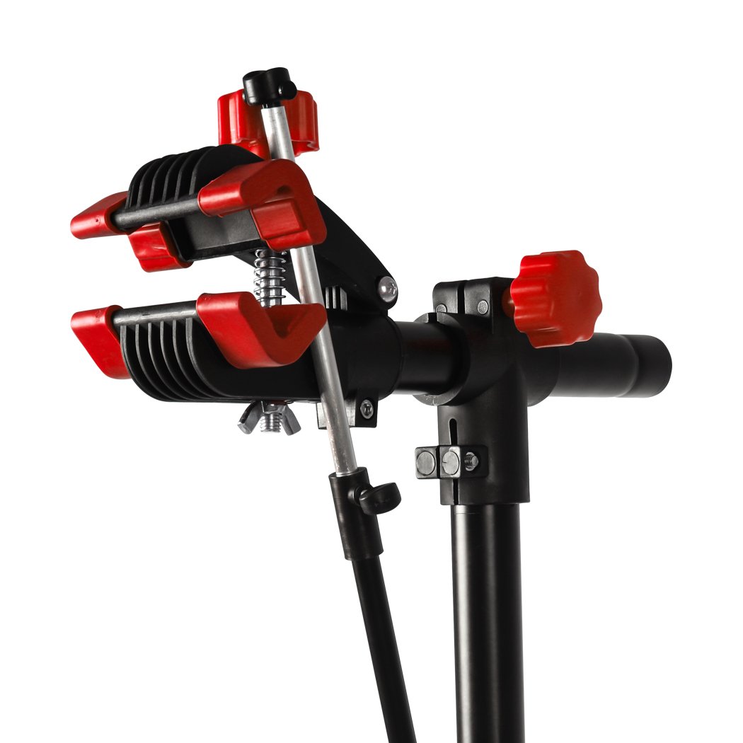 Ergonomic bike repair stand with tool tray, featuring a 360° swivel clamp and a sturdy four-legged base, ideal for home mechanics.