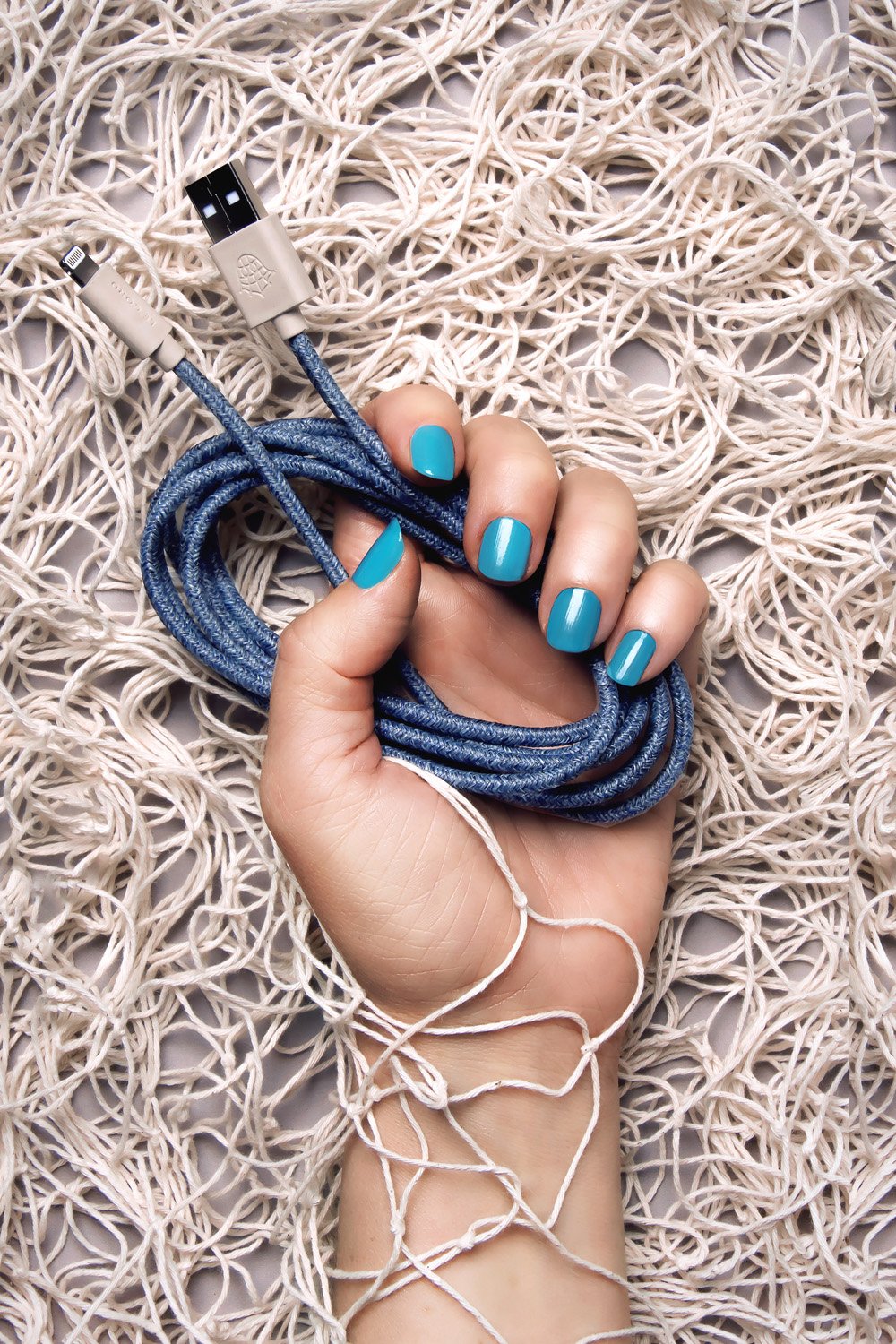 Bleu iPhone Lightning cable, 2 meters long, made from recycled fishing nets, featuring a braided textile sleeve.