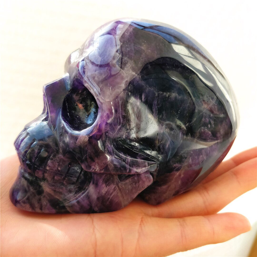 A beautifully hand-carved Brazilian Dream Amethyst skull with a polished finish, showcasing intricate details and rich purple hues.