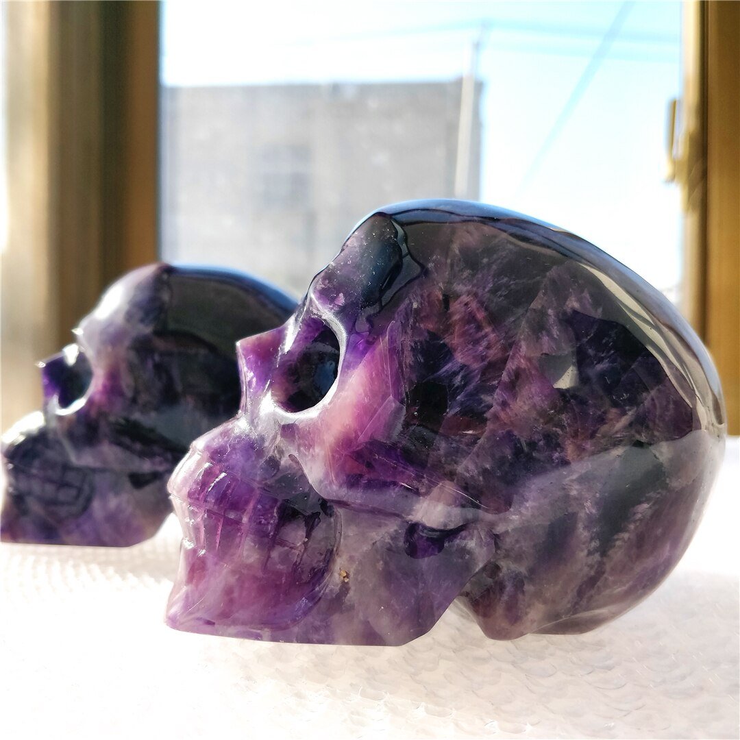 A beautifully hand-carved Brazilian Dream Amethyst skull with a polished finish, showcasing intricate details and rich purple hues.