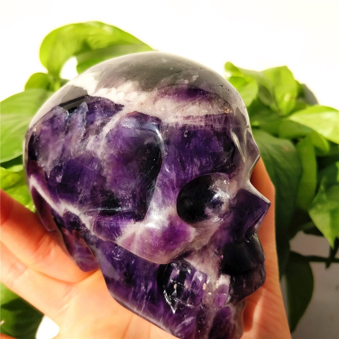 A beautifully hand-carved Brazilian Dream Amethyst skull with a polished finish, showcasing intricate details and rich purple hues.